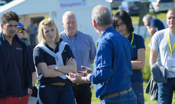 Group of people stood in a field.